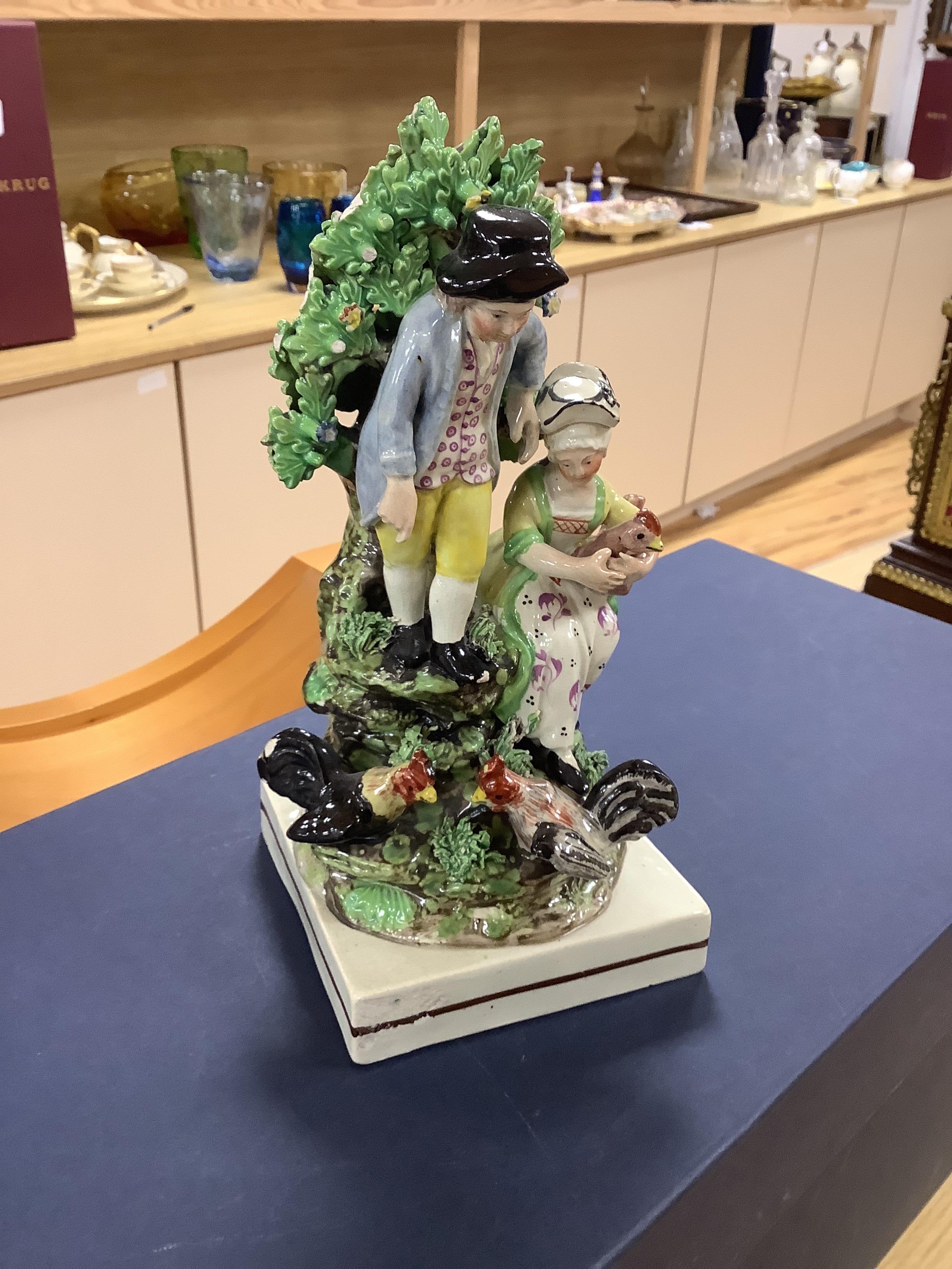 A Staffordshire pottery group of two figures with chickens, c.1800-10, a pair of early 20th century Staffordshire pottery figure groups and three small character figures, tallest 25cm high (6)